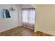 Dining room featuring modern lighting fixture, wood-look floors, and an archway leading to the kitchen at 12450 Stone Garden Dr, Huntersville, NC 28078