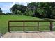 A backyard view from a wooden deck overlooking a large grassy yard with mature trees at 125 Heritage View Rd, Hickory, NC 28601