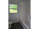 Bathroom featuring a tub shower with white walls, and tile flooring with a window at 125 Heritage View Rd, Hickory, NC 28601