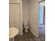 View of a bathroom featuring a toilet, vanity, and closet with white doors at 125 Heritage View Rd, Hickory, NC 28601