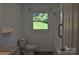Bright bathroom featuring a window, white fixtures, and a shower with safety bar at 125 Heritage View Rd, Hickory, NC 28601