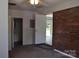 Cozy bedroom with neutral carpet, a painted brick accent wall, and easy access to the bathroom at 125 Heritage View Rd, Hickory, NC 28601