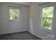 Bedroom featuring two windows offering great natural light and a view of trees at 125 Heritage View Rd, Hickory, NC 28601