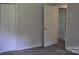 The light gray bedroom has carpet and ample closet space with natural light at 125 Heritage View Rd, Hickory, NC 28601