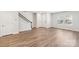 Open-concept living room with new wood-style flooring, staircase, and modern interior doors at 135 Utility Ln, Mooresville, NC 28117