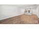 Open-concept living room with modern wood flooring and a view of the kitchen area at 135 Utility Ln, Mooresville, NC 28117