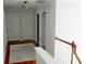 Bright hallway featuring hardwood floors, white trim, and access to multiple rooms at 13934 Kings Carriage Ln, Charlotte, NC 28278