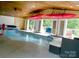 Indoor pool featuring kayaks, lounge chairs, multiple doors, basketball hoops, and views of the outdoors at 13934 Kings Carriage Ln, Charlotte, NC 28278