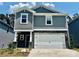 Charming two-story home features gray siding, stone accents, and a two-car garage at 1410 31St Ne St, Conover, NC 28613