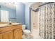 The bathroom contains a shower/tub, white tile, a wooden vanity and a toilet at 14222 Richmond Park Ave, Charlotte, NC 28277