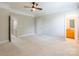 The bedroom features neutral carpet and walls, and a ceiling fan and has access to the bathroom at 14222 Richmond Park Ave, Charlotte, NC 28277