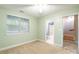Bedroom featuring a window, ceiling fan, carpet, and a view to an attached bathroom at 14222 Richmond Park Ave, Charlotte, NC 28277