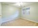 This bedroom has a window, carpet, and a ceiling fan with a light at 14222 Richmond Park Ave, Charlotte, NC 28277
