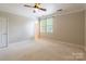This bedroom features a ceiling fan, neutral walls and carpet, and windows with blinds at 14222 Richmond Park Ave, Charlotte, NC 28277