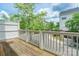 Deck with a wooden floor overlooking a tree-lined street and nearby houses at 14222 Richmond Park Ave, Charlotte, NC 28277