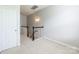 Upstairs hallway with carpet, a decorative railing, and a view of the stairs at 14222 Richmond Park Ave, Charlotte, NC 28277