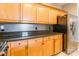 This kitchen features wooden cabinets, granite countertops, stainless refrigerator, and a tile backsplash at 14222 Richmond Park Ave, Charlotte, NC 28277