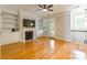 Inviting living room featuring a fireplace with built-in shelving and hardwood floors at 14222 Richmond Park Ave, Charlotte, NC 28277