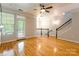 Spacious living room with hardwood floors, natural light, and staircase at 14222 Richmond Park Ave, Charlotte, NC 28277