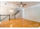 Open concept living room with hardwood floors and staircase at 14222 Richmond Park Ave, Charlotte, NC 28277