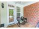 Relaxing front porch featuring rocking chairs and classic brick accents at 14222 Richmond Park Ave, Charlotte, NC 28277