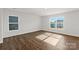 Bright bedroom with hardwood flooring, two large windows and views of the exterior at 1450 Mammoth Rd, Hickory, NC 28602