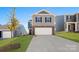 Charming two-story home featuring a brick and siding exterior, attached garage, and well-maintained lawn at 1450 Mammoth Rd, Hickory, NC 28602