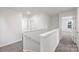 Upstairs hallway with neutral carpet and white trim with natural lighting at 1450 Mammoth Rd, Hickory, NC 28602