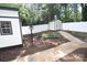Landscaped backyard with a stone path, shed, and privacy fence, providing a serene outdoor space at 1505 Clarendon Pl, Rock Hill, SC 29732
