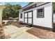 Stylish backyard shed boasts a white exterior, black trim, and a stone pathway at 1505 Clarendon Pl, Rock Hill, SC 29732