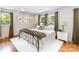 Inviting bedroom with a wrought iron bed frame, plush white rug, neutral decor, and abundant natural light at 1505 Clarendon Pl, Rock Hill, SC 29732