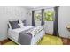 Bright bedroom showcasing a bed, windows, and a playful 'BOYCE' wall decor for a cozy and personalized space at 1505 Clarendon Pl, Rock Hill, SC 29732