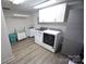 Bright laundry room featuring updated appliances and additional storage cabinets at 1505 Clarendon Pl, Rock Hill, SC 29732
