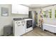 Well-equipped laundry room features modern washer, dryer, cabinets, and natural light at 1505 Clarendon Pl, Rock Hill, SC 29732