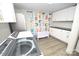 Well-equipped laundry room with modern washer and dryer, complemented by ample storage at 1505 Clarendon Pl, Rock Hill, SC 29732