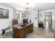 Bright office features a wooden desk, modern chandelier, and neutral walls and floors at 1505 Clarendon Pl, Rock Hill, SC 29732