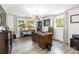 Stylish office showcasing a spacious desk, an elegant chandelier, windows, and modern decor at 1505 Clarendon Pl, Rock Hill, SC 29732
