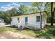 A white brick house with a blue door and a well-maintained lawn with greenery at 161 Ranson Rd, Lancaster, SC 29720