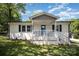 Charming single-story home featuring white painted brick and a covered front porch at 161 Ranson Rd, Lancaster, SC 29720