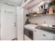 A laundry room features a washer, dryer, shelving, and storage space near the entry door at 161 Ranson Rd, Lancaster, SC 29720