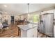 Bright living space showcasing hardwood flooring, a view of the kitchen, and comfortable seating at 161 Ranson Rd, Lancaster, SC 29720