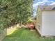 View of the backyard with a wooden deck, mature trees, and vinyl siding at 19509 Trintella Ln, Cornelius, NC 28031