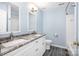 Modern bathroom featuring a double sink vanity, gray granite countertops, and updated fixtures at 19509 Trintella Ln, Cornelius, NC 28031