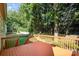 Large wooden deck overlooking a grassy backyard surrounded by mature trees at 19509 Trintella Ln, Cornelius, NC 28031
