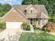 Beautiful brick home featuring a well-maintained lawn and mature trees at 19509 Trintella Ln, Cornelius, NC 28031