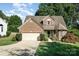 Charming brick home with manicured lawn, mature trees, and a two-car garage at 19509 Trintella Ln, Cornelius, NC 28031