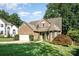 Charming brick home with manicured lawn, mature trees, and a two-car garage at 19509 Trintella Ln, Cornelius, NC 28031