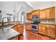 Kitchen featuring stainless steel appliances, granite counters, and wood cabinetry at 19509 Trintella Ln, Cornelius, NC 28031