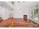 Bright living room with fireplace, hardwood floors, and large windows at 19509 Trintella Ln, Cornelius, NC 28031