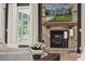 Stone fireplace with a wooden mantel and mounted television in a cozy living room at 204 Coronado Ave, Matthews, NC 28104